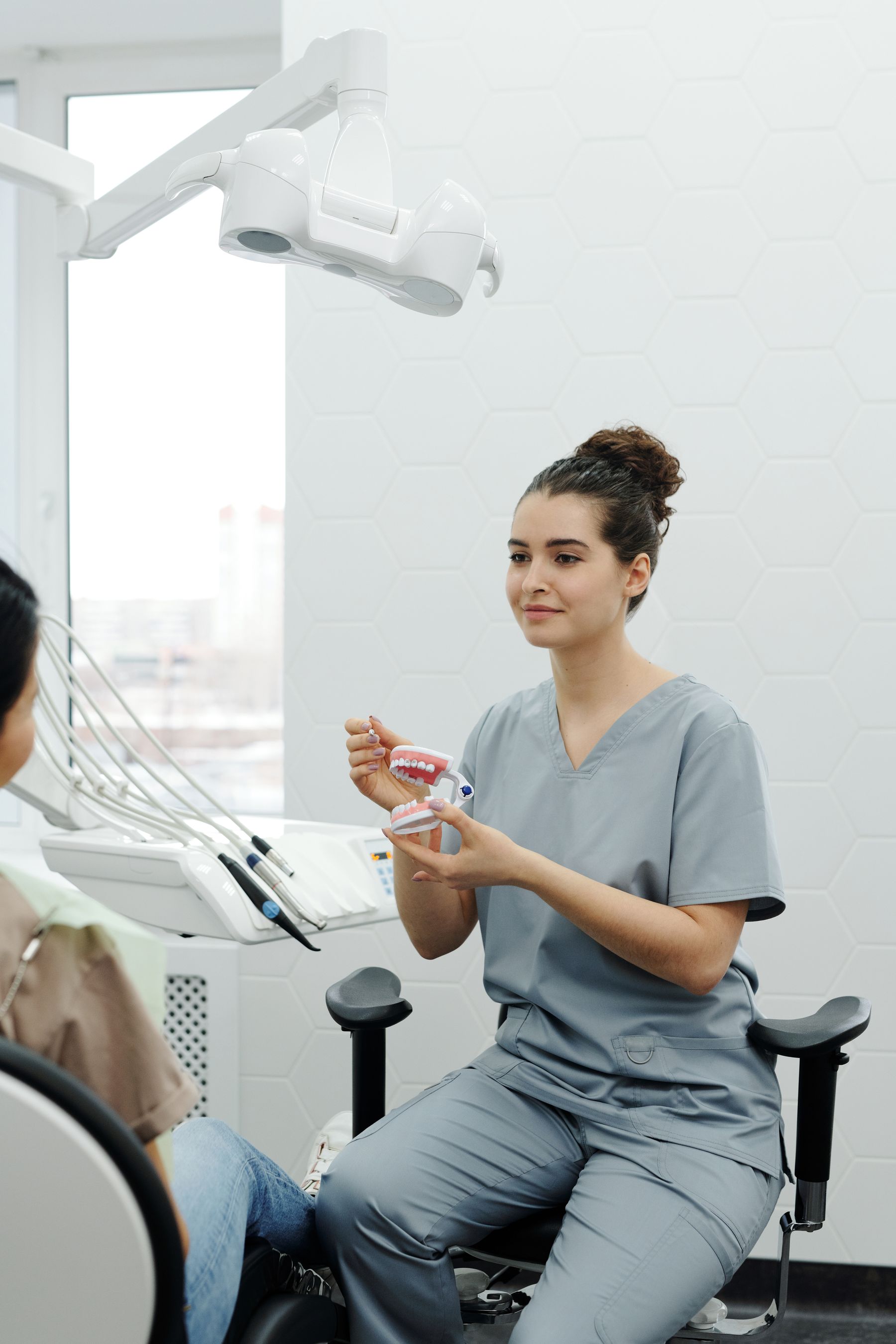 Dental professional explaining a treatment model to a patient